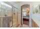 Bathroom with shower, double vanity, and view into bedroom at 5373 Sleeping Cat St, Las Vegas, NV 89122
