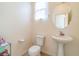 Clean bathroom with pedestal sink and updated toilet at 5373 Sleeping Cat St, Las Vegas, NV 89122