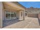 View of the backyard featuring a covered patio with brick pavers, a blank canvas for outdoor activities, and a block wall fence at 63 Ibiza Lake Dr, Henderson, NV 89011