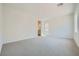 Spacious bedroom with a large window, neutral carpet, and an ensuite bathroom at 63 Ibiza Lake Dr, Henderson, NV 89011