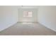 Cozy bedroom with neutral carpet, natural light, and a spacious closet at 63 Ibiza Lake Dr, Henderson, NV 89011