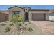 Charming one-story home with a desert landscape, brick driveway, and a two-car garage at 63 Ibiza Lake Dr, Henderson, NV 89011