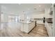 Modern kitchen features an island, stainless appliances, and an open view of the living area at 63 Ibiza Lake Dr, Henderson, NV 89011