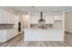 Modern kitchen with a large island, gray backsplash, stainless steel appliances, and white cabinets at 63 Ibiza Lake Dr, Henderson, NV 89011