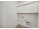 Functional laundry area featuring white cabinets and space for a washer and dryer at 63 Ibiza Lake Dr, Henderson, NV 89011