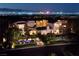 An aerial view showcases a luxurious estate with manicured grounds, a water feature, and stunning city views at 641 Saint Croix St, Henderson, NV 89012