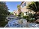 Beautifully landscaped backyard features a water feature, lush greenery, and an outdoor seating area at 641 Saint Croix St, Henderson, NV 89012