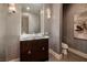 This bathroom features sleek silver wallpaper, modern lighting and a vanity with a stone countertop at 641 Saint Croix St, Henderson, NV 89012