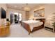 Well lit bedroom with decorative mirror, wood bed frame and access to the patio at 641 Saint Croix St, Henderson, NV 89012