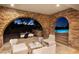 Retreat to the stone-arched patio with cozy seating, offering scenic views of the pool and city lights beyond at 641 Saint Croix St, Henderson, NV 89012