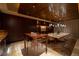 Expansive dining space features a long stone table, modern lighting, and custom wood accents at 641 Saint Croix St, Henderson, NV 89012