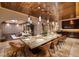 Large dining room with stone table and seating for ten with views to the living area at 641 Saint Croix St, Henderson, NV 89012