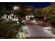 Night view of an upscale home with manicured landscaping, stone arch and elegant stairs at 641 Saint Croix St, Henderson, NV 89012