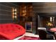 Features a stylish bar area with a mini-fridge, a cozy fireplace, and a chic red sofa at 641 Saint Croix St, Henderson, NV 89012
