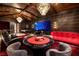 A stylish game room offers a poker table, a large screen for entertainment, and a comfortable red sofa at 641 Saint Croix St, Henderson, NV 89012