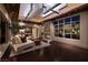 Sophisticated living room with fireplace, dark wood floors, and views of the landscaped exterior at 641 Saint Croix St, Henderson, NV 89012