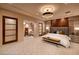 A peaceful bedroom features wood accents, soft neutral tones, and a seating area at 641 Saint Croix St, Henderson, NV 89012