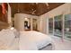 This serene main bedroom features a wood ceiling, neutral colors and access to the yard at 641 Saint Croix St, Henderson, NV 89012
