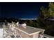 Outdoor bar area offering views of city lights, an outdoor fireplace, and bar seating at 641 Saint Croix St, Henderson, NV 89012
