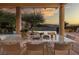 Covered patio with outdoor dining and amazing sunset views overlooking the pool and lush backyard landscaping at 641 Saint Croix St, Henderson, NV 89012