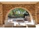 The outdoor lounge area is framed by stone arches and lush greenery, offering a relaxing space at 641 Saint Croix St, Henderson, NV 89012