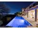 The luxurious infinity pool is illuminated at night, offering views of the city skyline at 641 Saint Croix St, Henderson, NV 89012