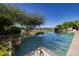 Inviting infinity pool with lush landscaping and distant views, perfect for relaxation at 641 Saint Croix St, Henderson, NV 89012