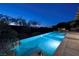 An illuminated pool provides stunning views of the city skyline and surrounding landscape in the evening at 641 Saint Croix St, Henderson, NV 89012