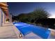 Inviting swimming pool features an elongated design, blue lighting, and meticulously landscaped surroundings at 641 Saint Croix St, Henderson, NV 89012