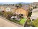 Aerial view of a private backyard with a putting green, covered patio, and modern landscaping at 664 Orchard Course Dr, Las Vegas, NV 89148