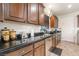 Modern kitchen featuring dark countertops and wood cabinetry with stainless steel appliances at 664 Orchard Course Dr, Las Vegas, NV 89148