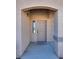 Inviting front entrance with a covered porch and neutral-colored door at 8805 Jeffreys St # 1115, Las Vegas, NV 89123