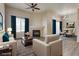 Virtually staged living room with fireplace, hardwood floors, and dining area at 8805 Jeffreys St # 1115, Las Vegas, NV 89123