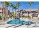 Community pool with surrounding lounge chairs at 8805 Jeffreys St # 1115, Las Vegas, NV 89123