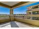 Expansive balcony view showcasing a pristine golf course and elegant adjacent building at 9133 Las Manaitas Ave # 302, Las Vegas, NV 89144