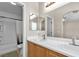 Bathroom featuring double sinks, bright lighting, and a shower with bathtub at 9323 Leaping Deer Pl # 102, Las Vegas, NV 89178