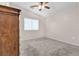 Bright bedroom featuring a ceiling fan and a window with blinds at 9323 Leaping Deer Pl # 102, Las Vegas, NV 89178