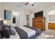 Comfortable bedroom featuring a large bed, dresser with TV, and ensuite bathroom at 9323 Leaping Deer Pl # 102, Las Vegas, NV 89178