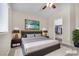 Cozy bedroom featuring a comfortable bed, closet, and television at 9323 Leaping Deer Pl # 102, Las Vegas, NV 89178