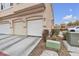 A row of townhomes with garages and landscaping at 9323 Leaping Deer Pl # 102, Las Vegas, NV 89178