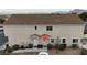Exterior photo of two-story tan home with two front doors and manicured landscaping at 9323 Leaping Deer Pl # 102, Las Vegas, NV 89178