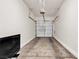 Spacious two car garage featuring high ceilings and ample room for storage and parking at 9323 Leaping Deer Pl # 102, Las Vegas, NV 89178