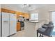 Eat in Kitchen with oak cabinets, breakfast bar, and stainless steel appliances at 9323 Leaping Deer Pl # 102, Las Vegas, NV 89178