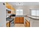 Well-equipped kitchen with stainless steel appliances and wood cabinetry at 9323 Leaping Deer Pl # 102, Las Vegas, NV 89178
