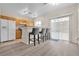 Kitchen with wooden cabinets, stainless steel appliances, and a bar area at 9323 Leaping Deer Pl # 102, Las Vegas, NV 89178