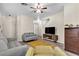 Living room with grey sofas, wood floors, and a ceiling fan at 9323 Leaping Deer Pl # 102, Las Vegas, NV 89178