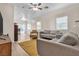 Well-lit living room with modern furnishings, light-colored flooring, and sliding glass door at 9323 Leaping Deer Pl # 102, Las Vegas, NV 89178
