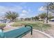 A grassy community park with picnic benches and mature trees at 9323 Leaping Deer Pl # 102, Las Vegas, NV 89178