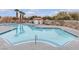 Community pool with clear blue water and surrounding trees at 9323 Leaping Deer Pl # 102, Las Vegas, NV 89178