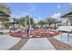 Community workout area featuring exercise equipment, shaded seating and accessible concrete paths at 9323 Leaping Deer Pl # 102, Las Vegas, NV 89178